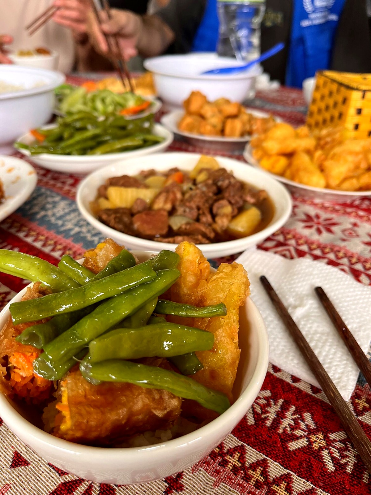 Shared dishes and vegetables on the group’s lunch table