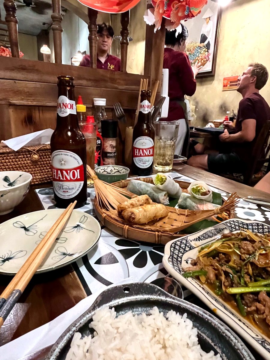 Beers and fried spring rolls on a Hanoi dinner table