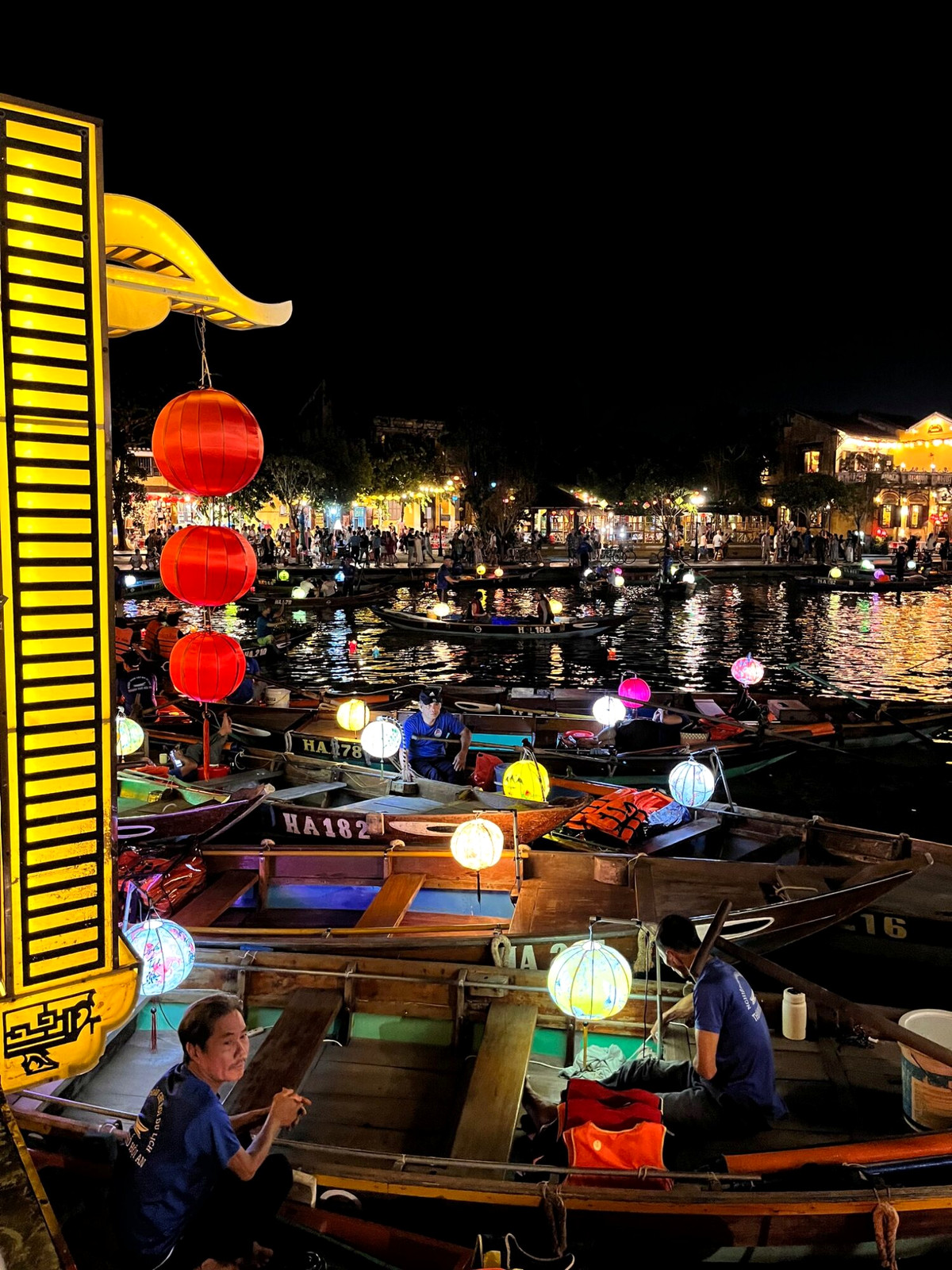 Lantern boats glowing on the river in Hoi An at night