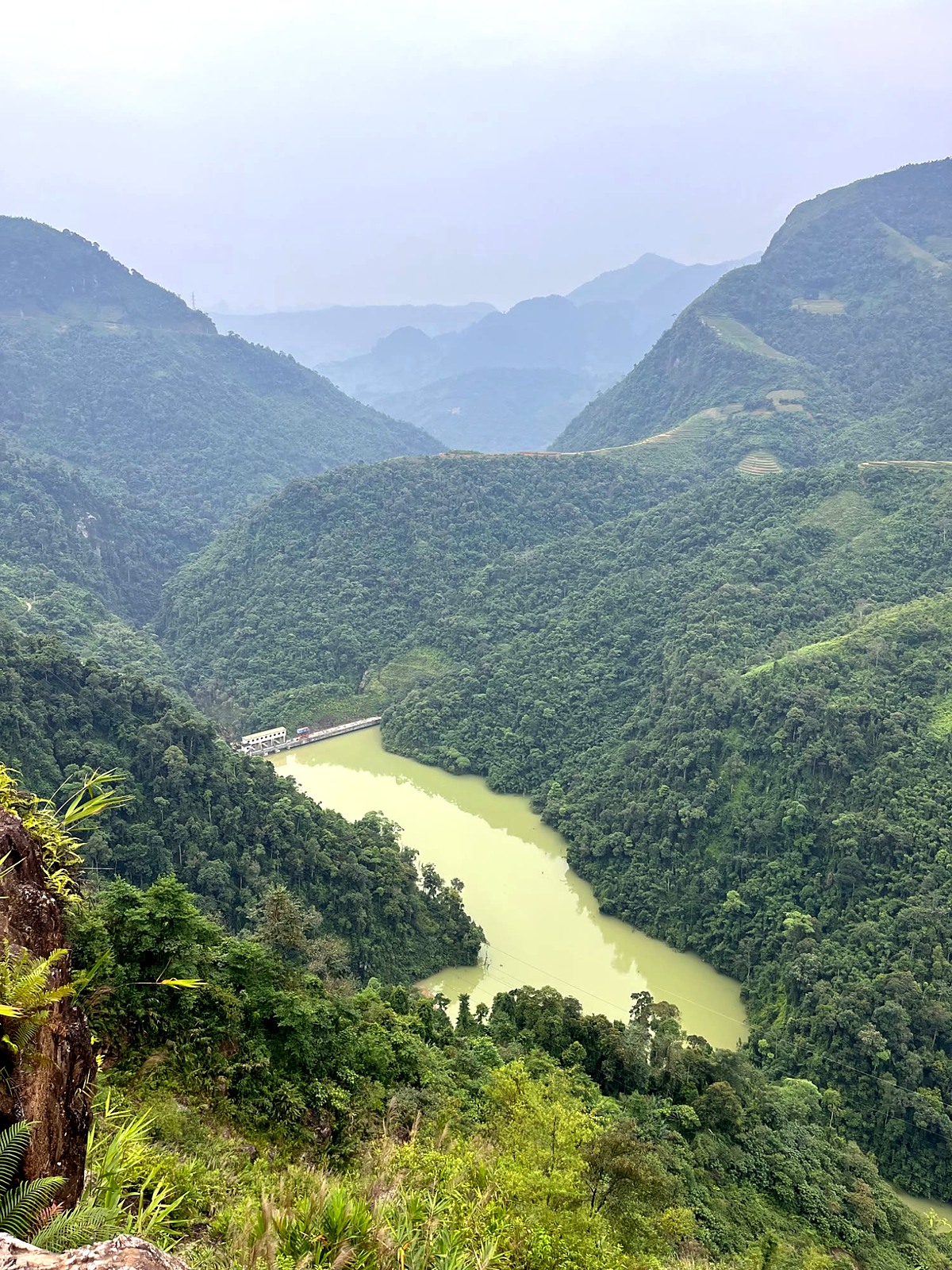 A river winding between green mountains on the Hà Giang Loop
