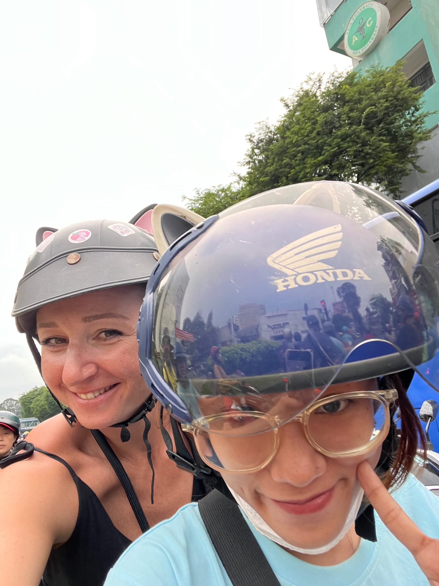 Andreja and her rider Rae smiling for a scooter selfie in Saigon