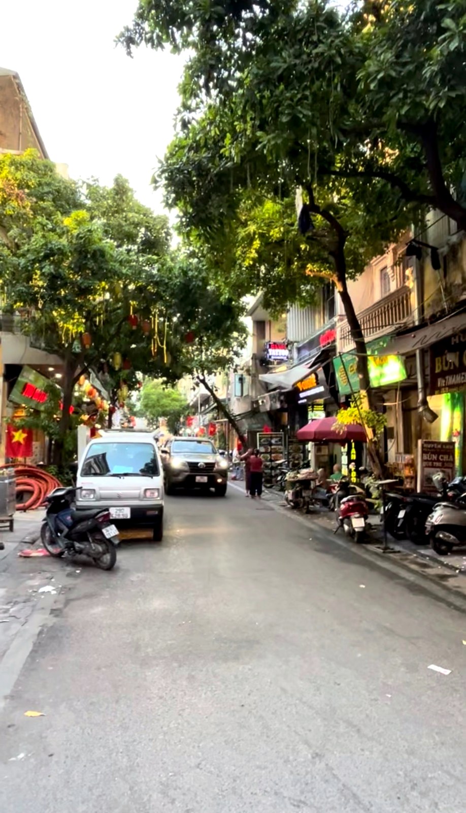 A quiet tree-lined street in the Hanoi Old Quarter
