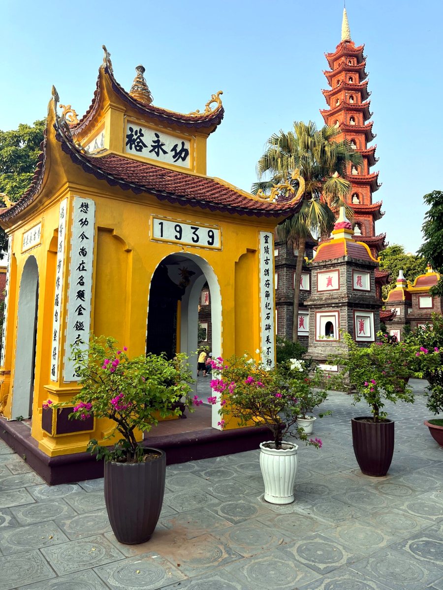Yellow shrine and red tower of Tran Quoc Pagoda