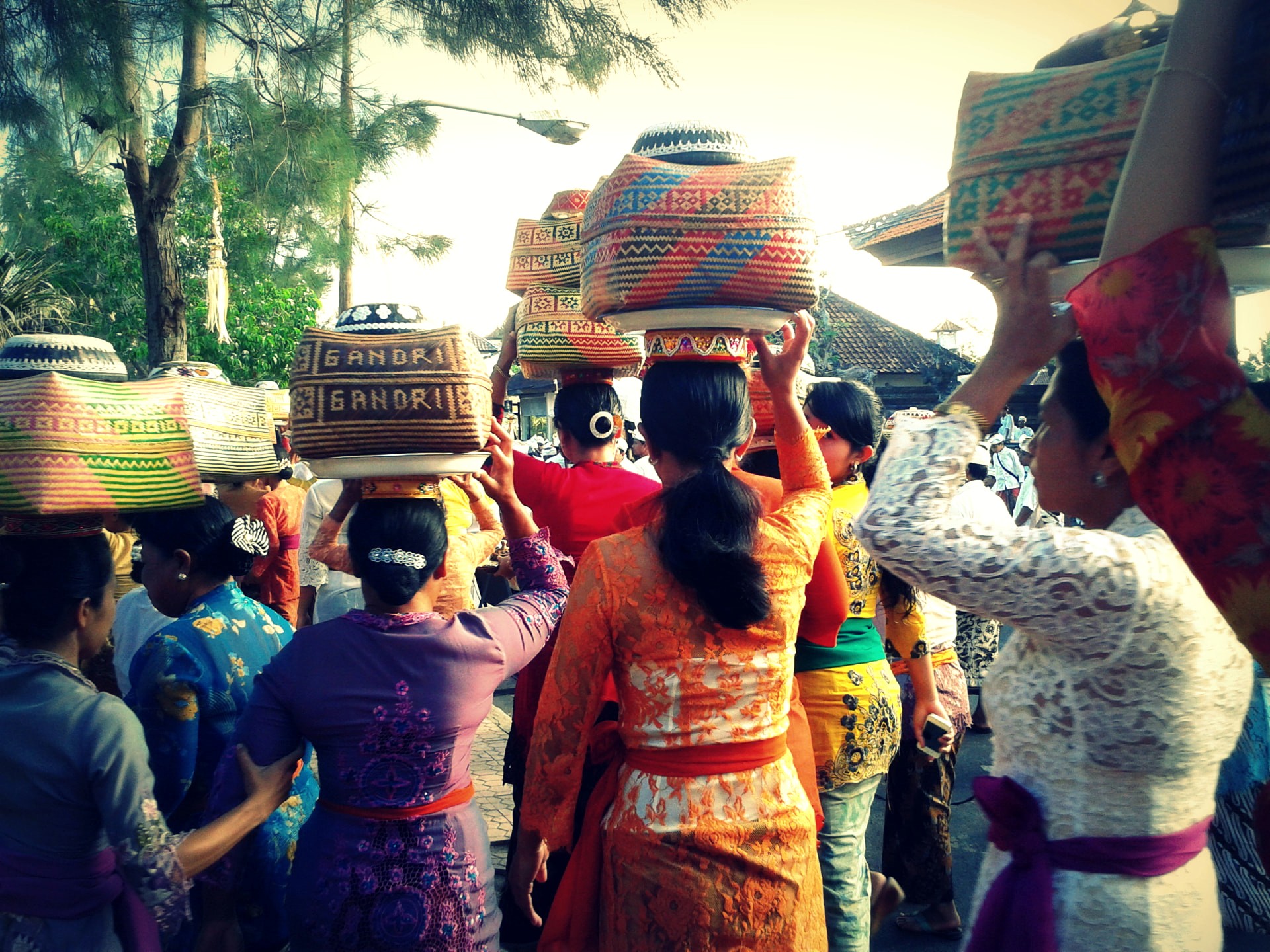 Balinese women carrying offering baskets during an odalan procession in Ubud