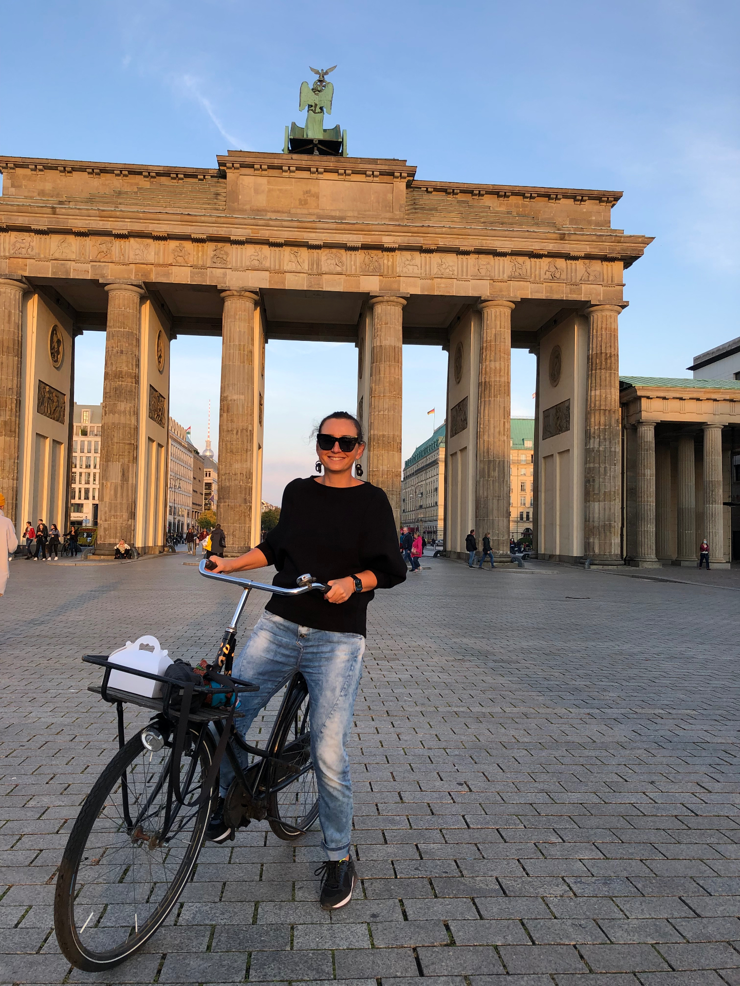 Cycling past the Brandenburg Gate at sunset, Berlin