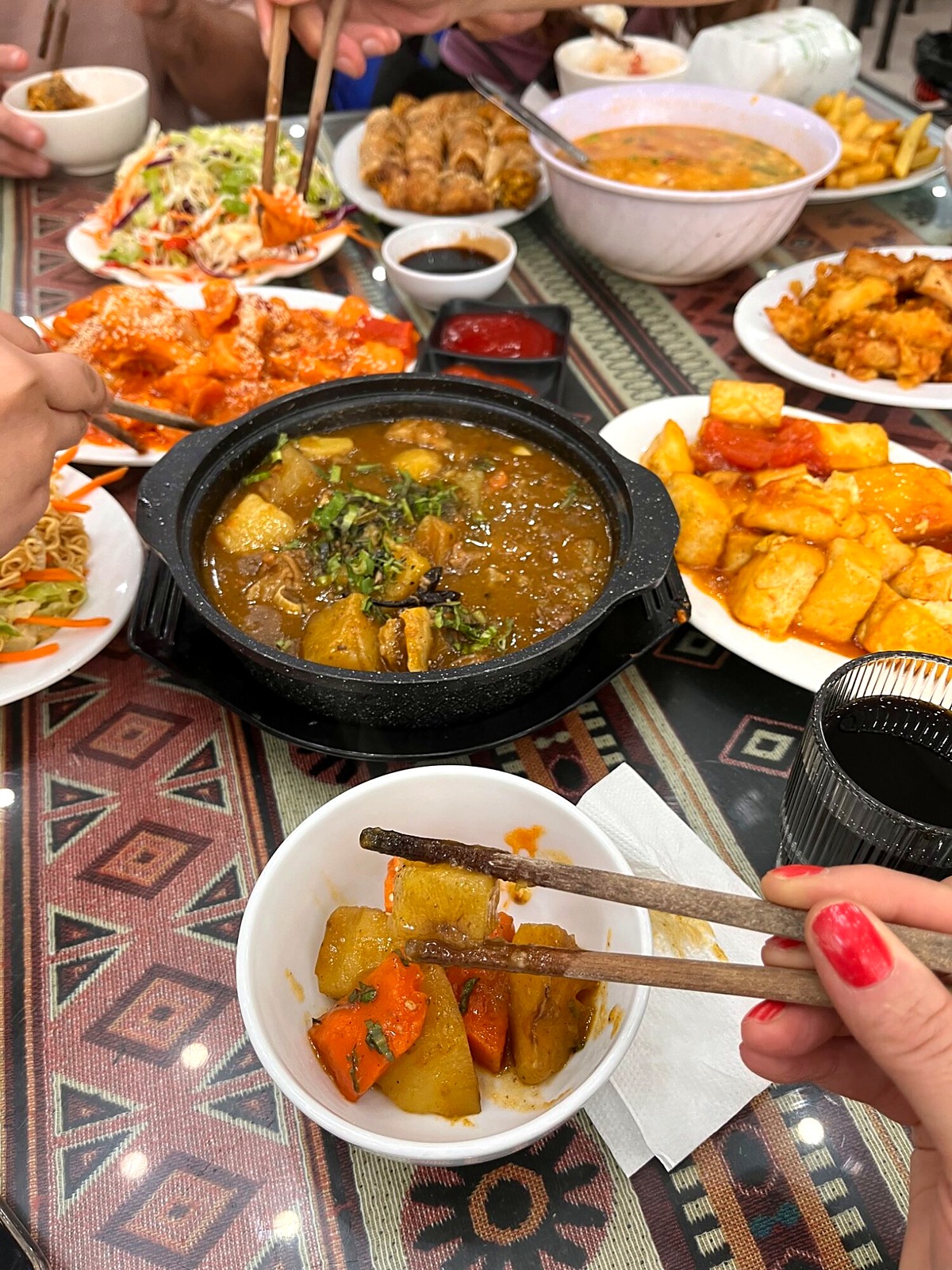 A hot dish surrounded by plates at a group meal
