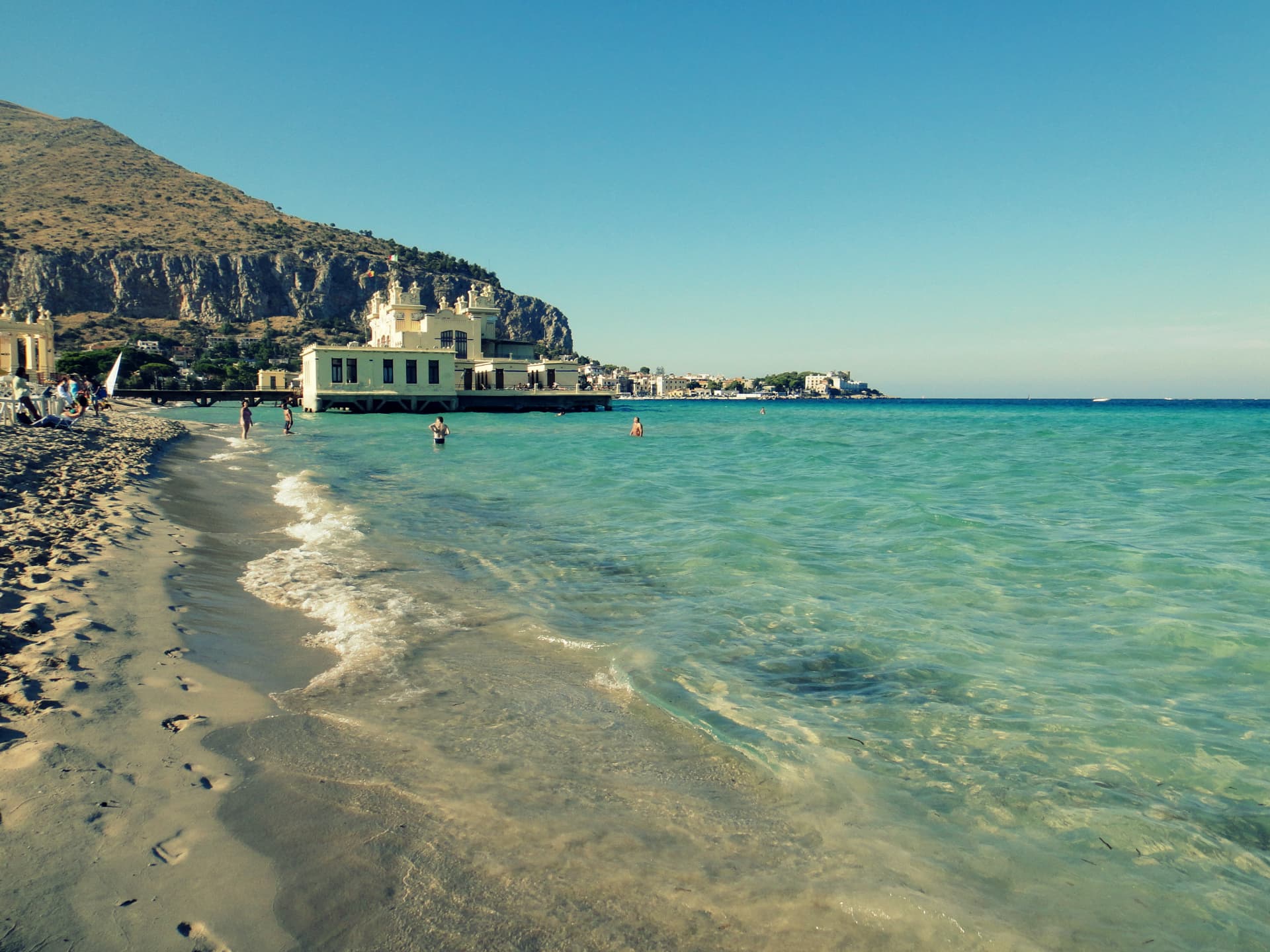 Turquoise shallow water and pale sand at Mondello Beach near Palermo