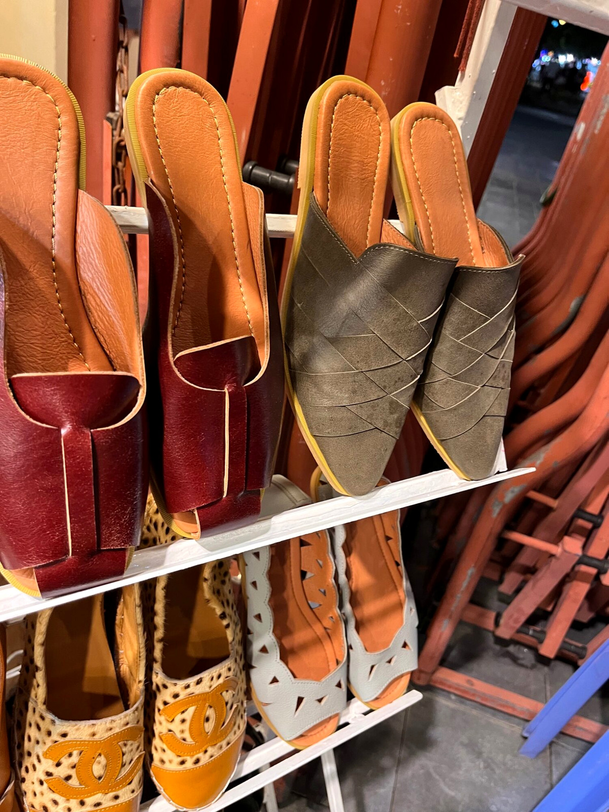 Close-up of leather sandals in different colours and styles on shop shelves