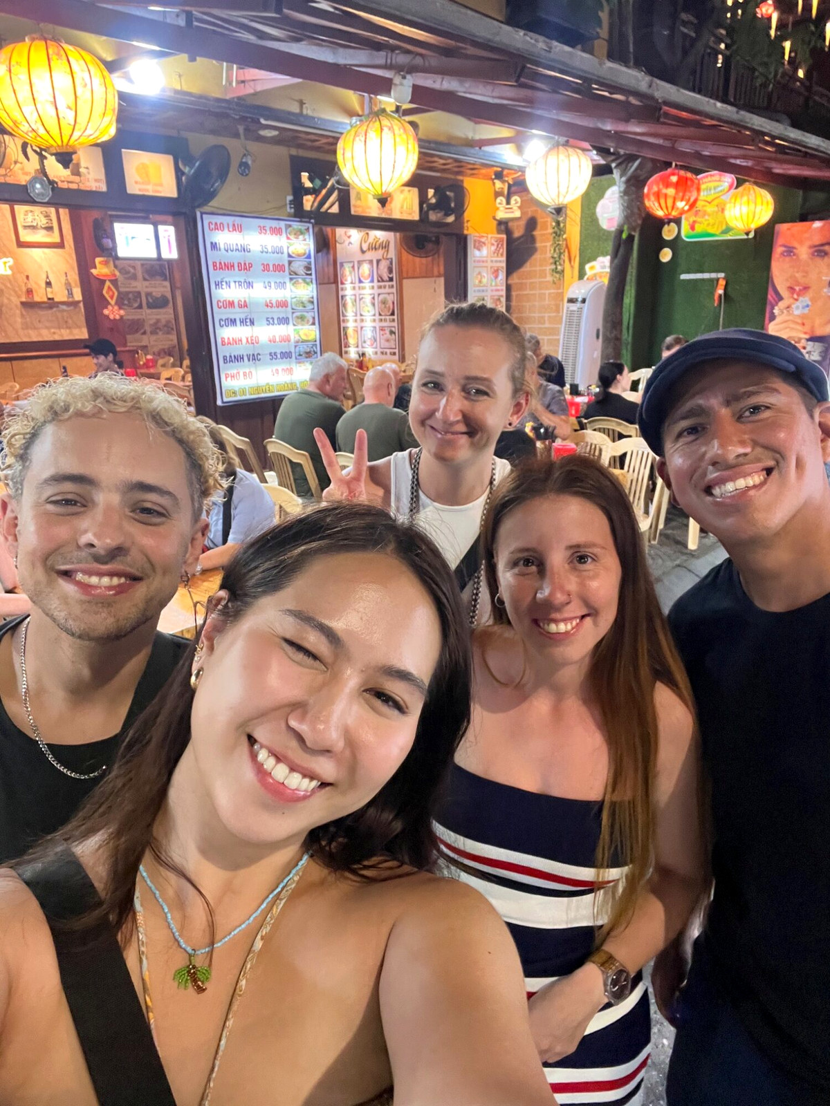 Andreja and friends taking a smiling group selfie at Tiger bar in Hoi An