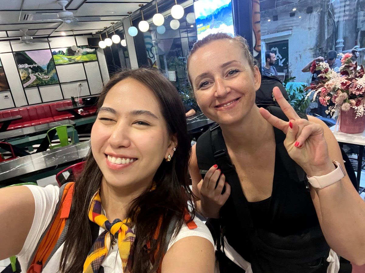 Two friends with backpacks reunited in Hanoi