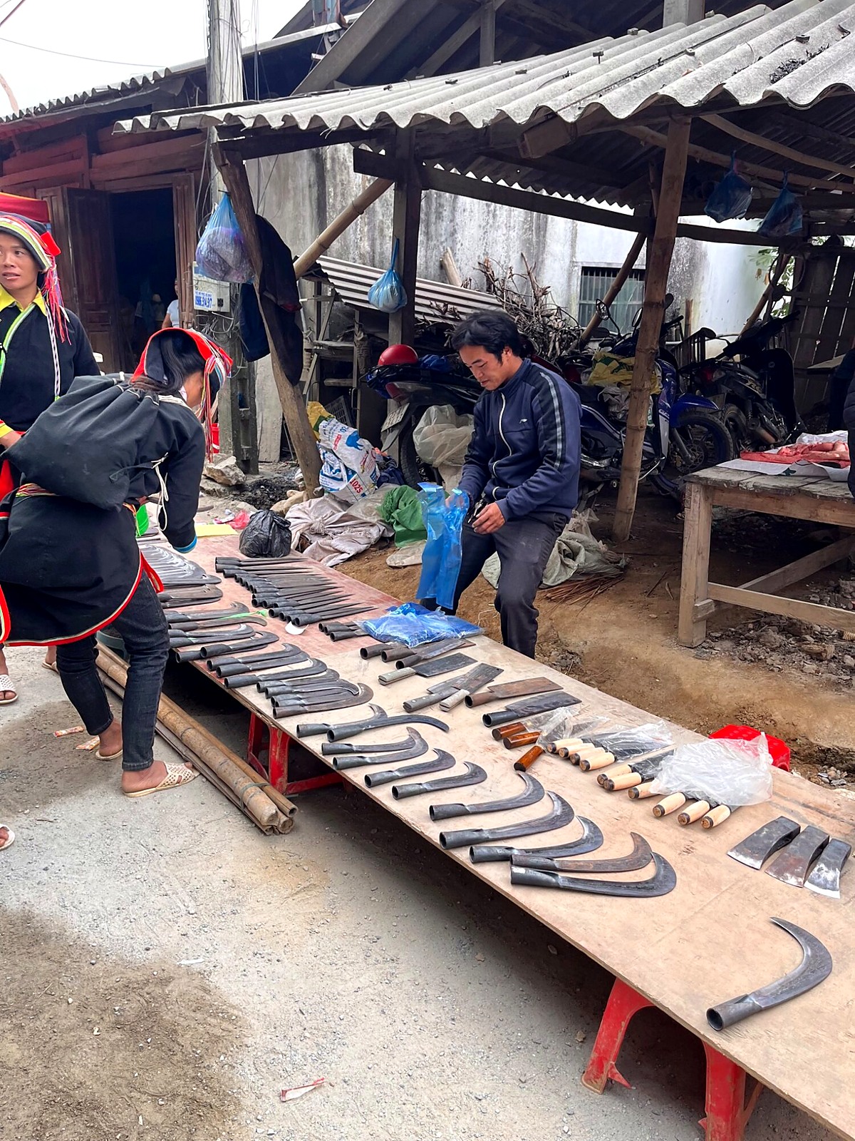 Machetes displayed on a table at a local market