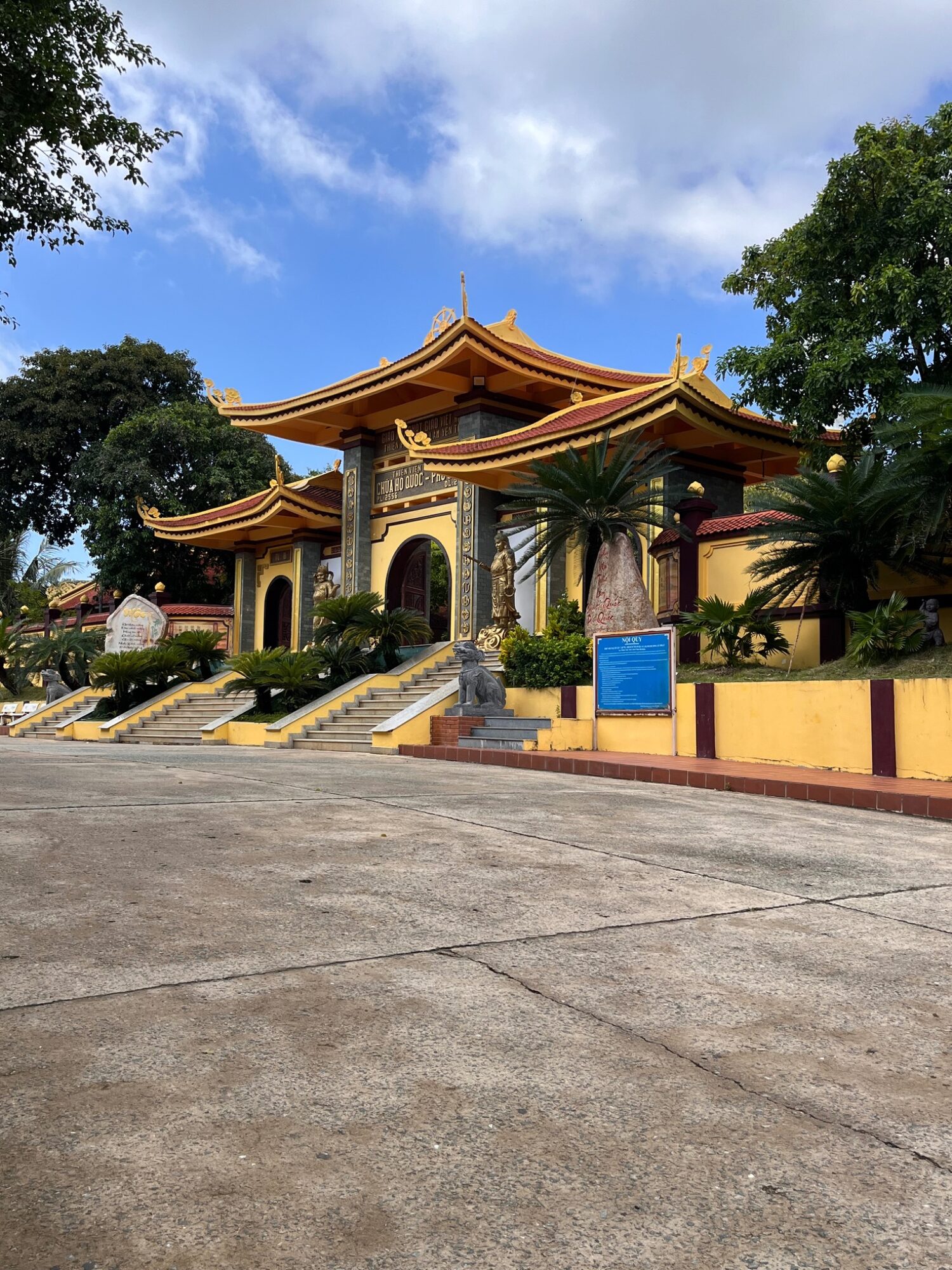 Yellow entrance gate and tree-lined steps at Ho Quoc Pagoda on Phu Quoc