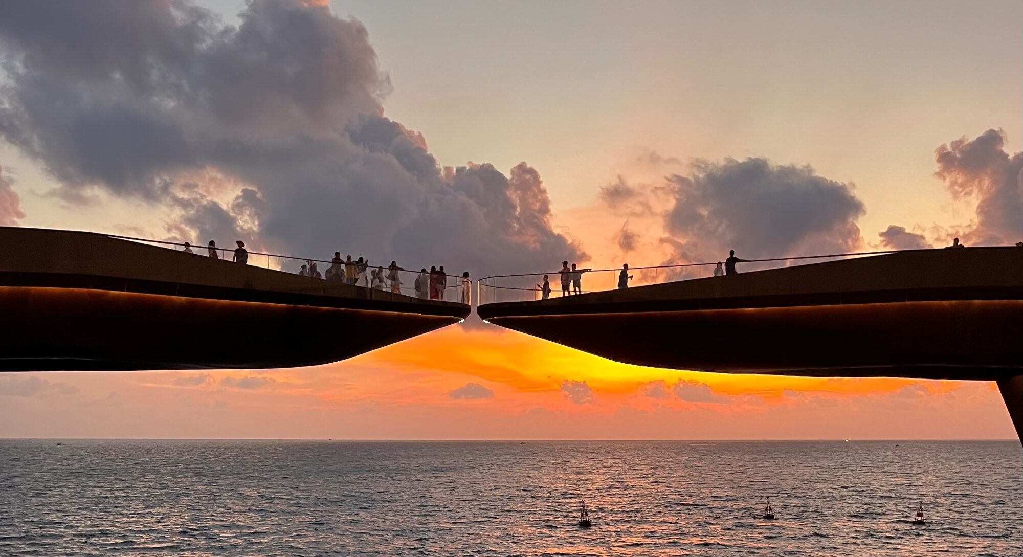 The two halves of Kiss Bridge on Phu Quoc above the sea at a golden sunset