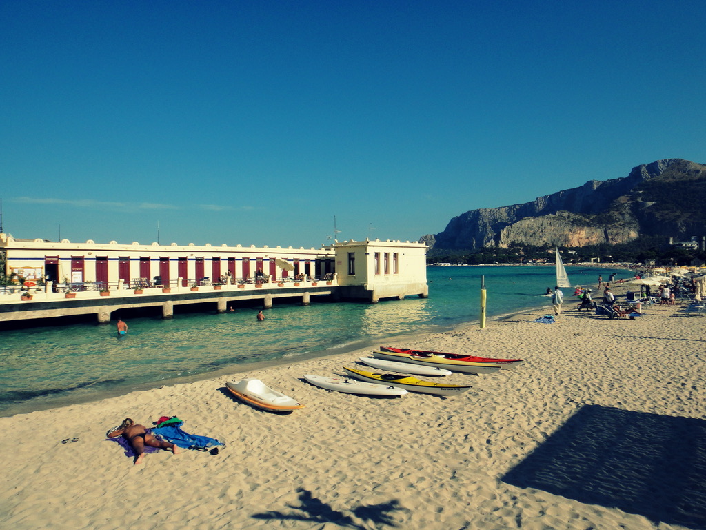 Mondello beach outside Palermo with kayaks on the sand and turquoise water