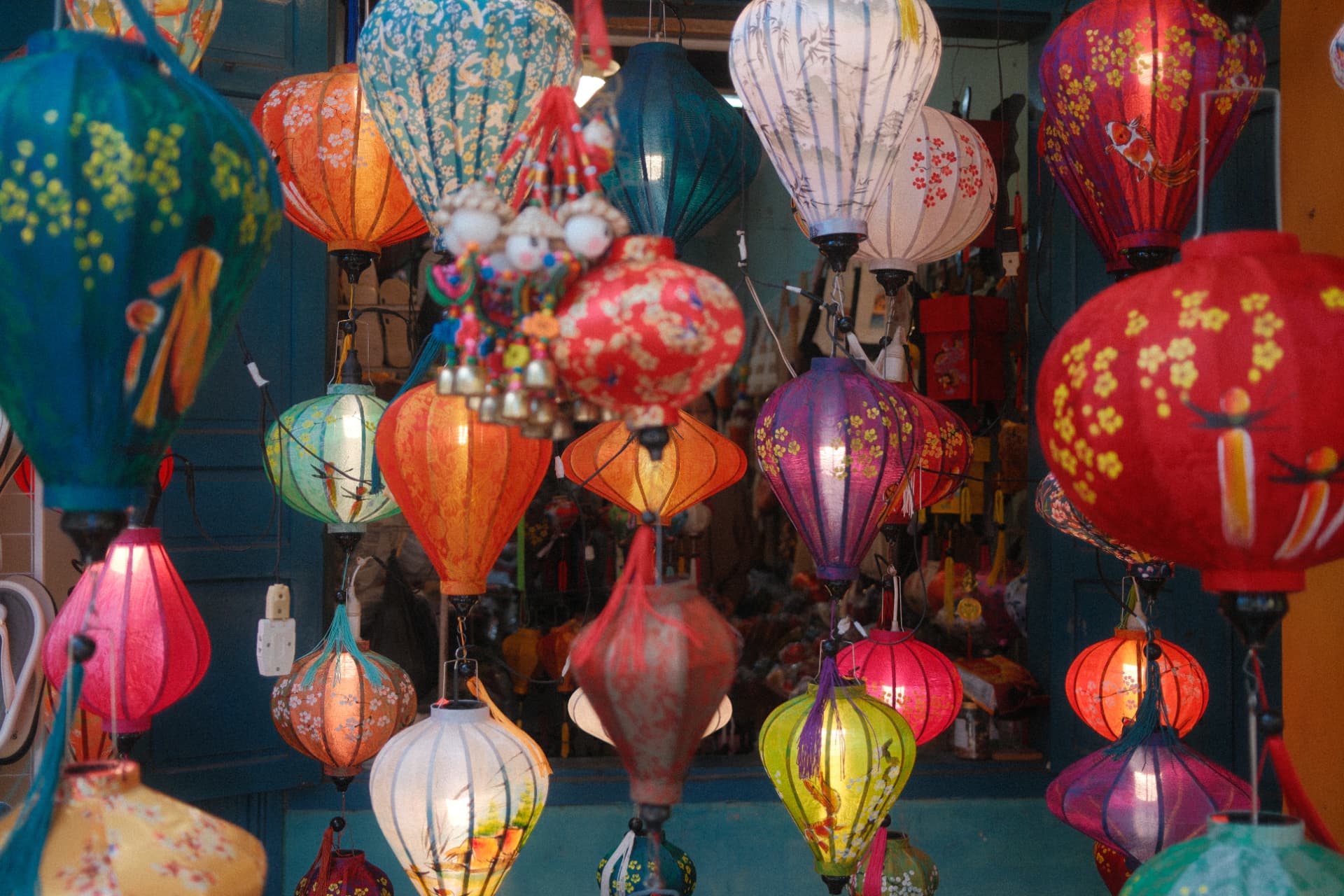 Colourful traditional Vietnamese lanterns in red, orange, blue and purple hanging in rows